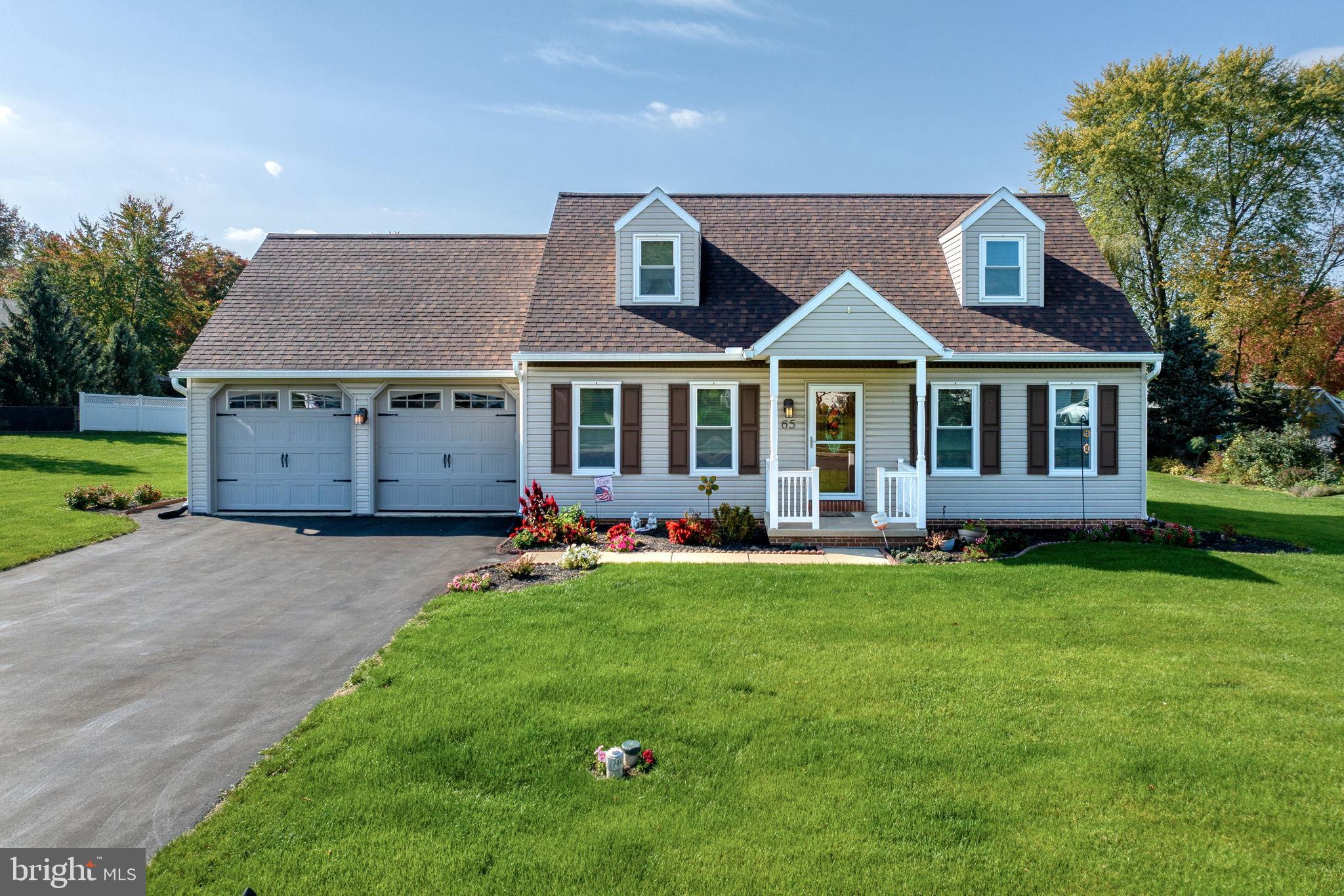 65 Winding Way Lititz, PA 17543 - Photo 1 of 28 a front view of a house with a garden and porch