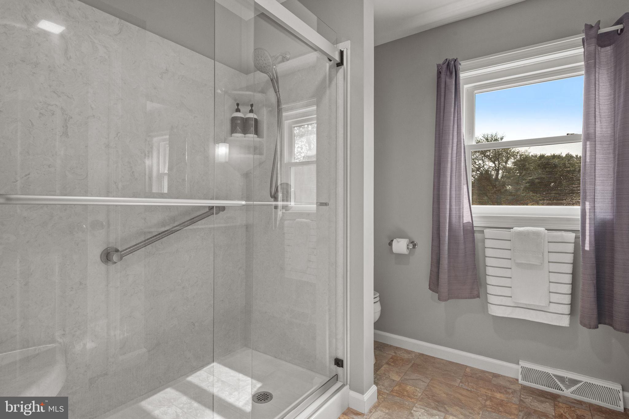 65 Winding Way Lititz, PA 17543 - Photo 18 of 28 a bathroom with a glass shower door