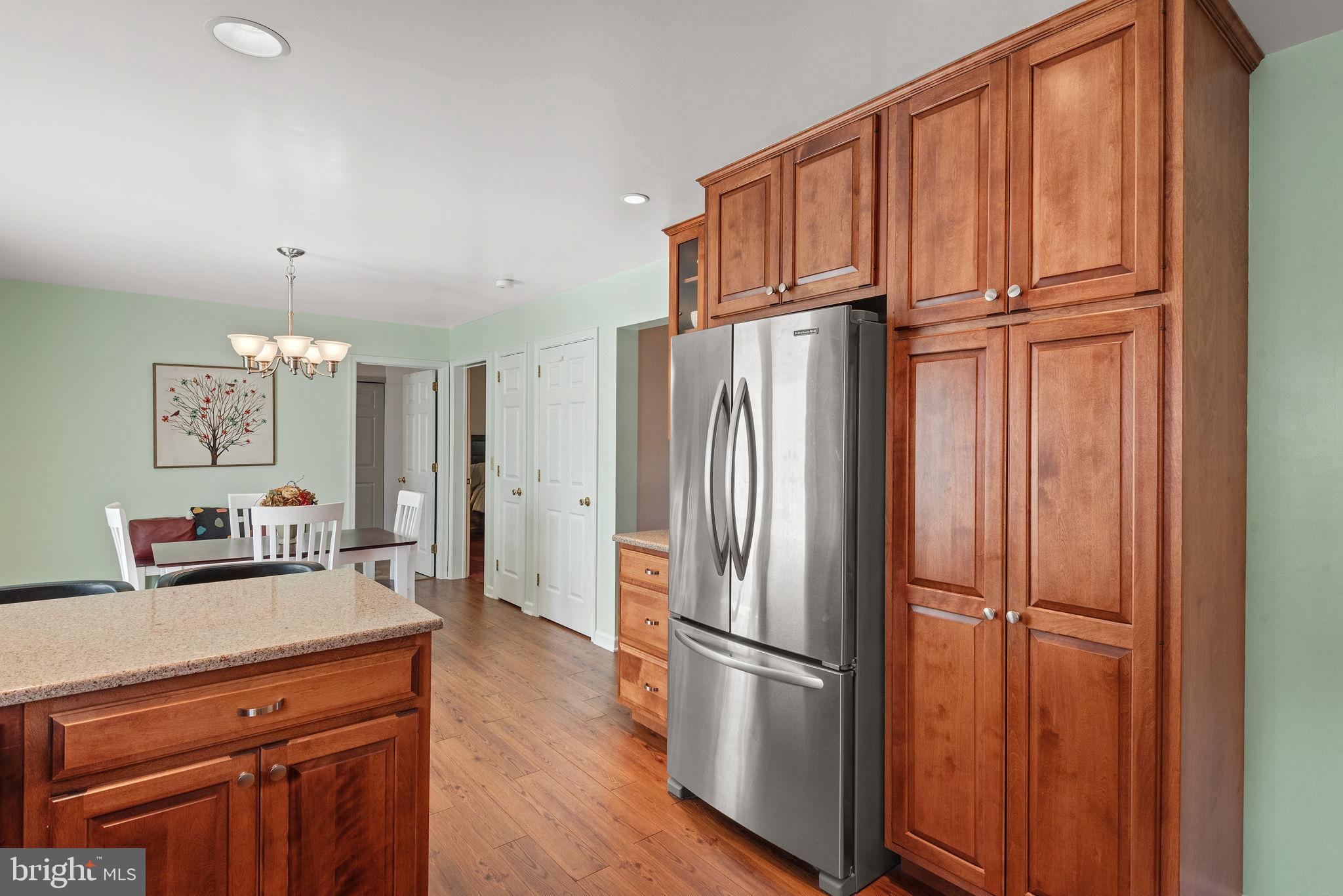 65 Winding Way Lititz, PA 17543 - Photo 7 of 28 a kitchen with stainless steel appliances a refrigerator and wooden floor
