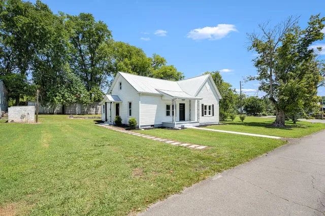 a view of a house with yard and a garden