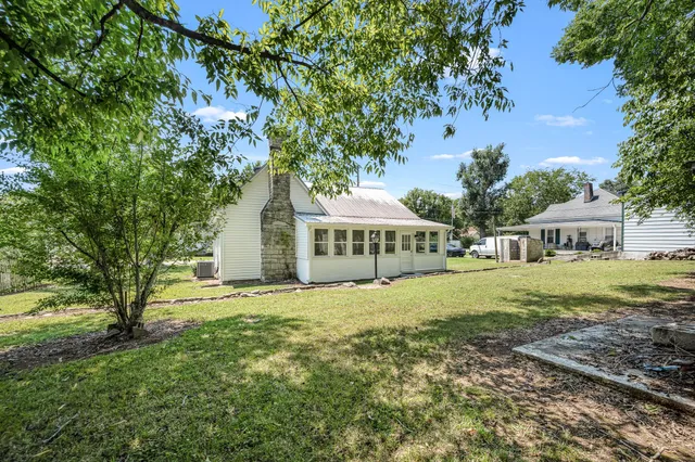 a view of a backyard with a large tree