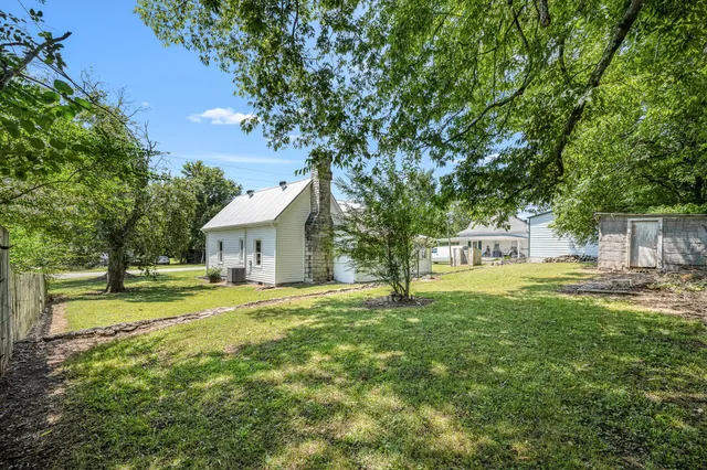 a house with huge green field in front of it