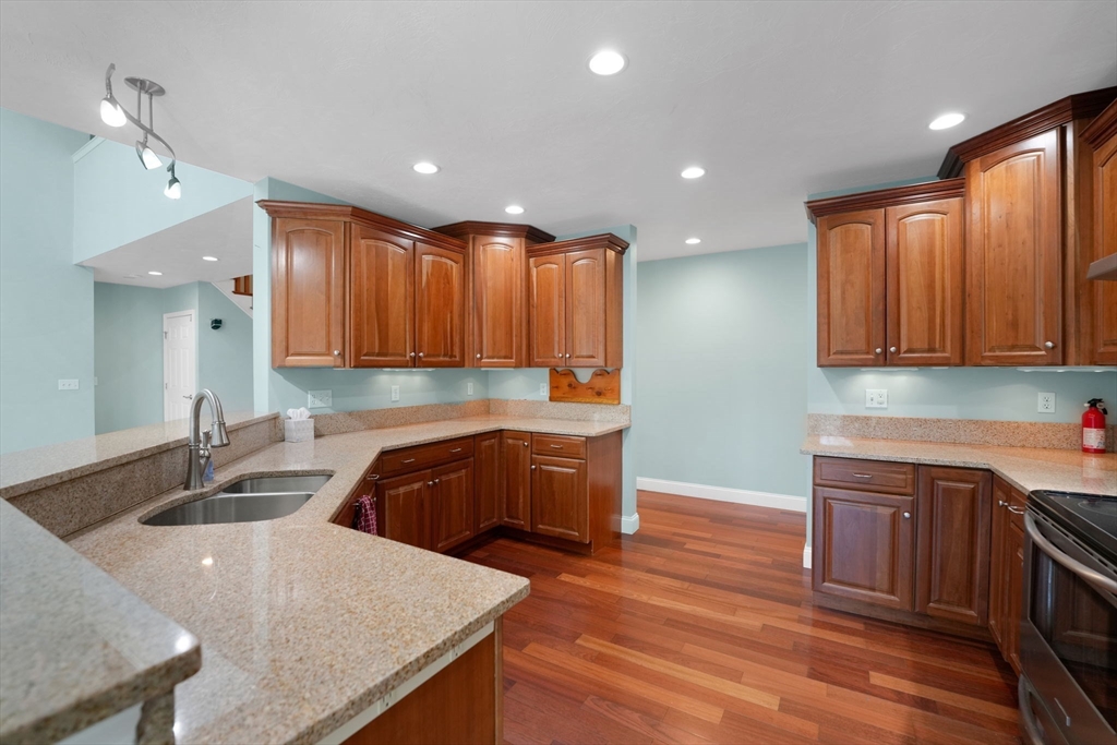 7 Cranberry Lane Wareham, MA 02538 - Photo 13 of 42 a kitchen with granite countertop a sink a stove and cabinets