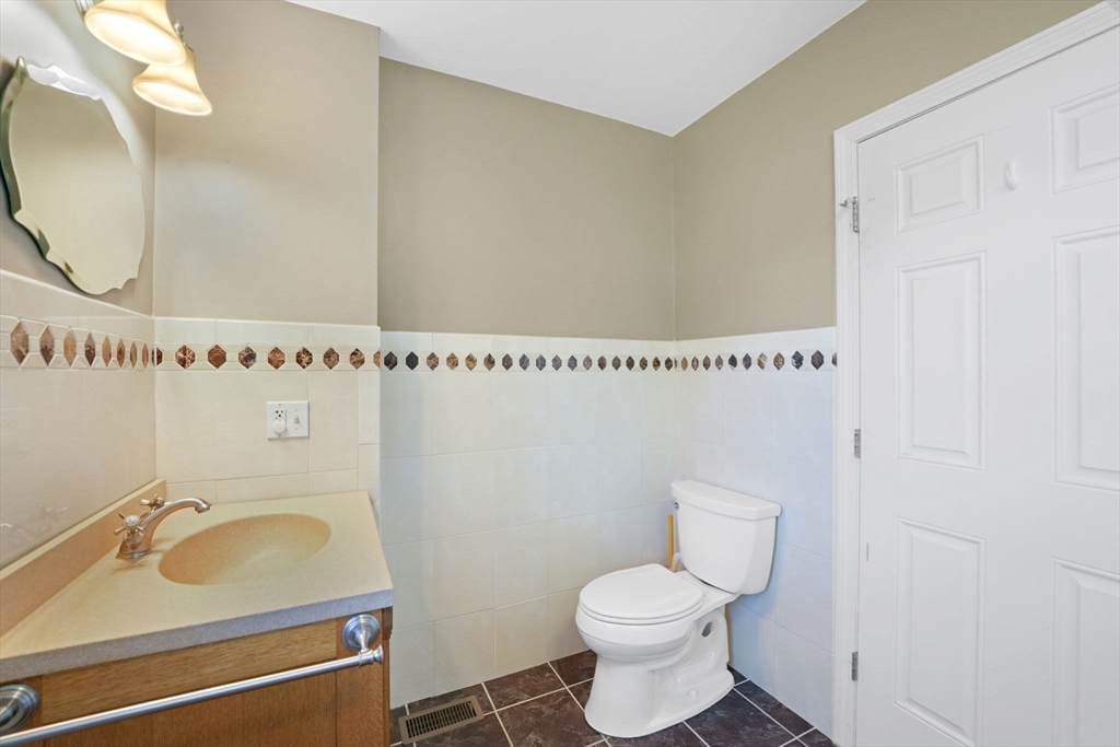 7 Cranberry Lane Wareham, MA 02538 - Photo 15 of 42 a bathroom with a sink a toilet and a mirror