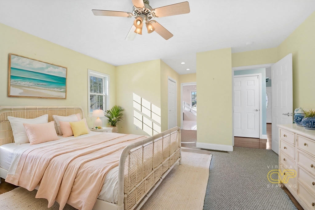 7 Cranberry Lane Wareham, MA 02538 - Photo 23 of 42 a bedroom with a bed and a chandelier