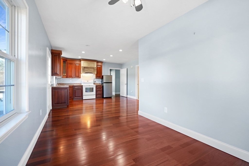 7 Cranberry Lane Wareham, MA 02538 - Photo 26 of 42 an empty room with wooden floor kitchen view and a window