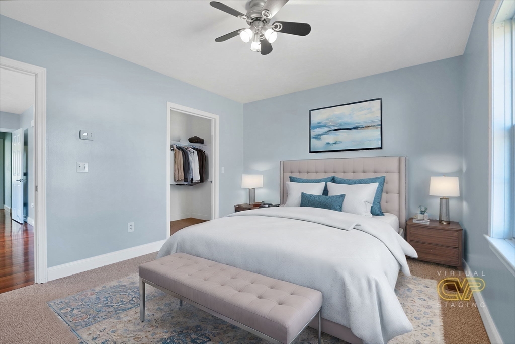 7 Cranberry Lane Wareham, MA 02538 - Photo 29 of 42 a bedroom with a bed and a chandelier