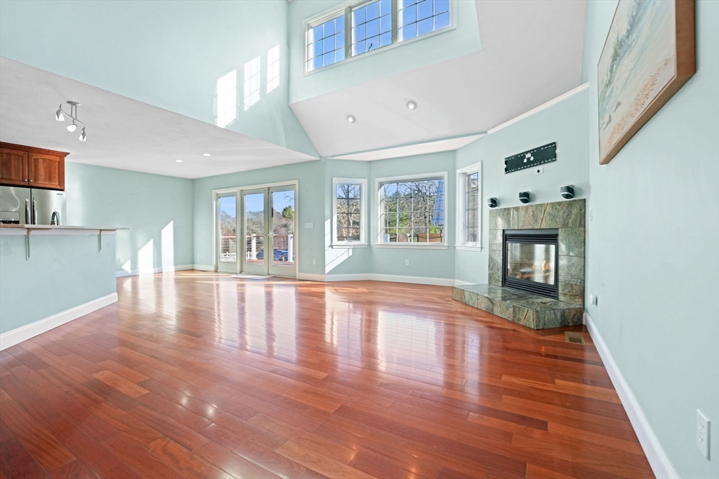 7 Cranberry Lane Wareham, MA 02538 - Photo 8 of 42 a view of an empty room with wooden floor and a window