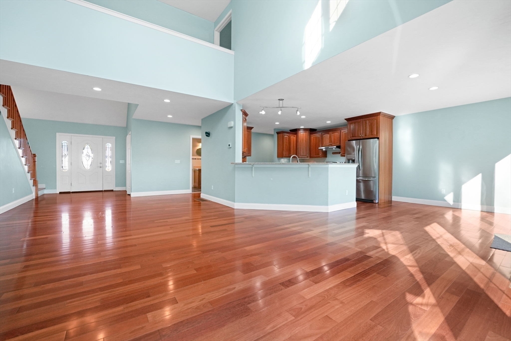 7 Cranberry Lane Wareham, MA 02538 - Photo 10 of 42 a view of a room with a flat screen tv and wooden floor