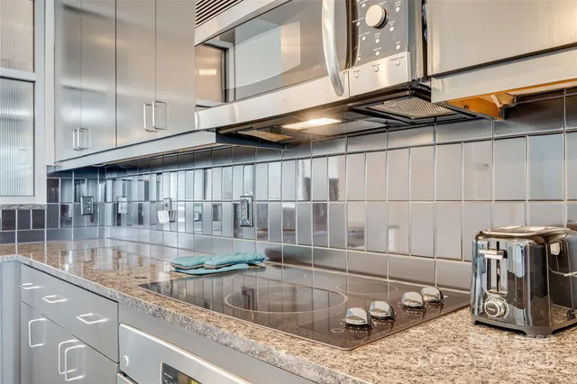 a living room with furniture a flat screen tv and a large window