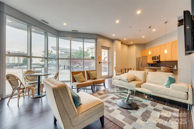 a kitchen with a table chairs wooden floors and wooden cabinets