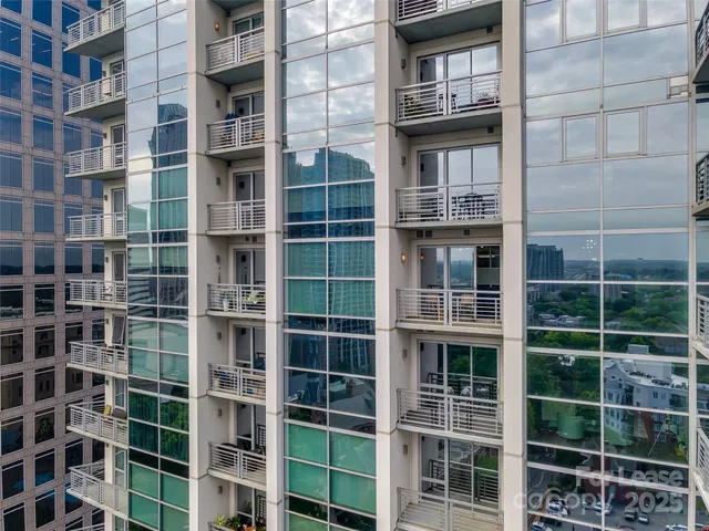 an aerial view of a house with a swimming pool patio and outdoor seating