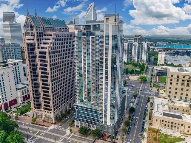 an aerial view of residential houses with outdoor space and parking