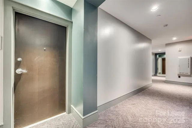 a view of bedroom with a large bed and mirror