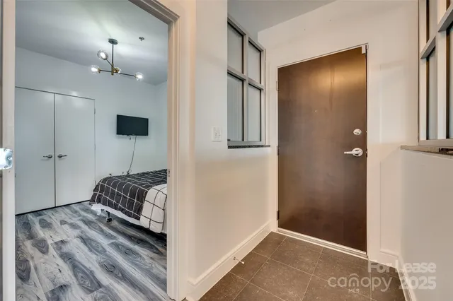 a bedroom with a bed and a chandelier