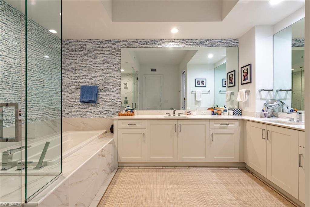 1135 3rd Avenue South, Unit 308 Naples, FL 34102 - Photo 11 of 18 a spacious bathroom with a tub sink shower and mirror