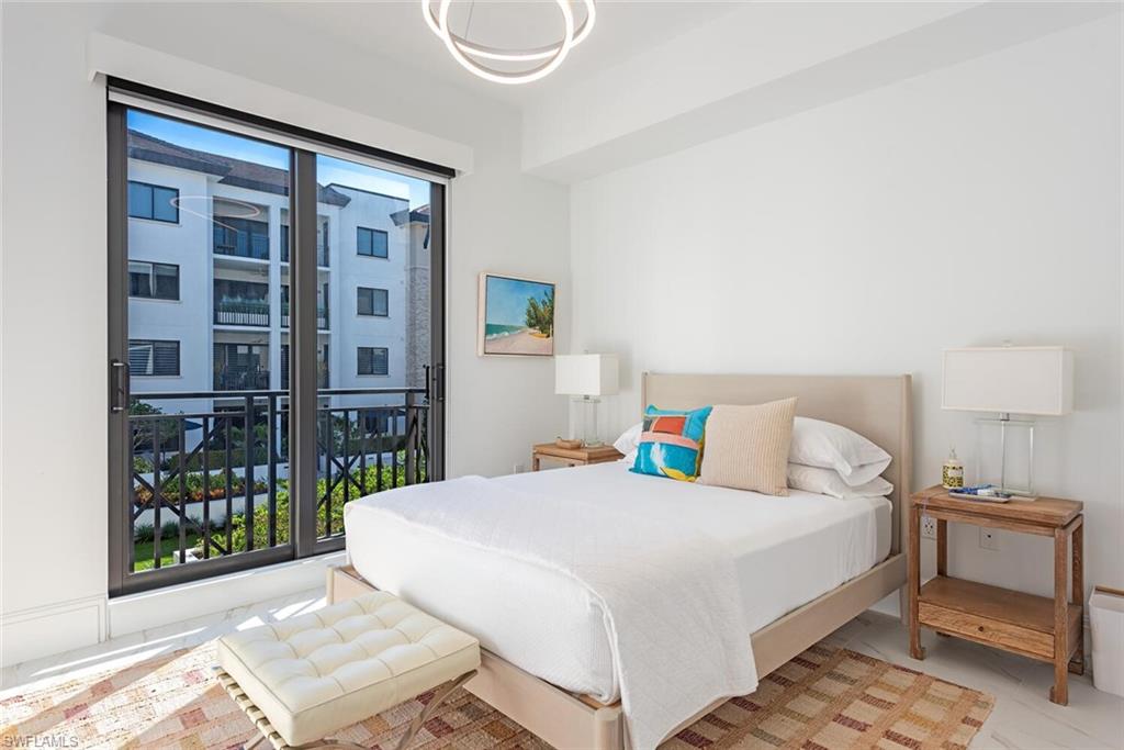 1135 3rd Avenue South, Unit 308 Naples, FL 34102 - Photo 12 of 18 a bedroom with a bed and a window