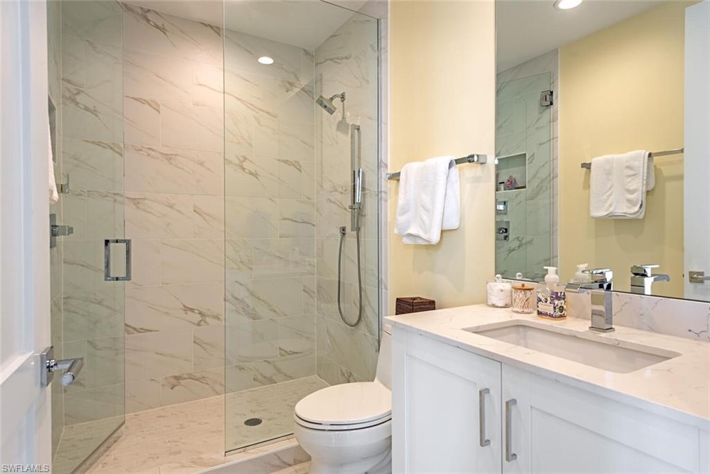 1135 3rd Avenue South, Unit 308 Naples, FL 34102 - Photo 13 of 18 a bathroom with a sink a toilet and shower