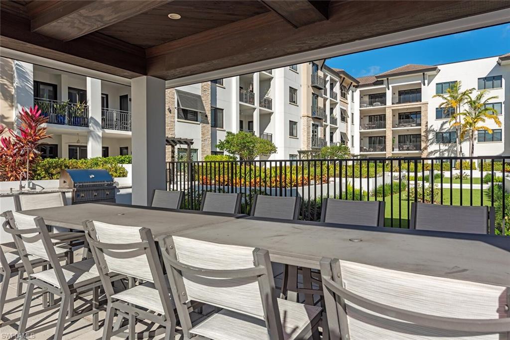 1135 3rd Avenue South, Unit 308 Naples, FL 34102 - Photo 18 of 18 a view of a patio with a table and chairs