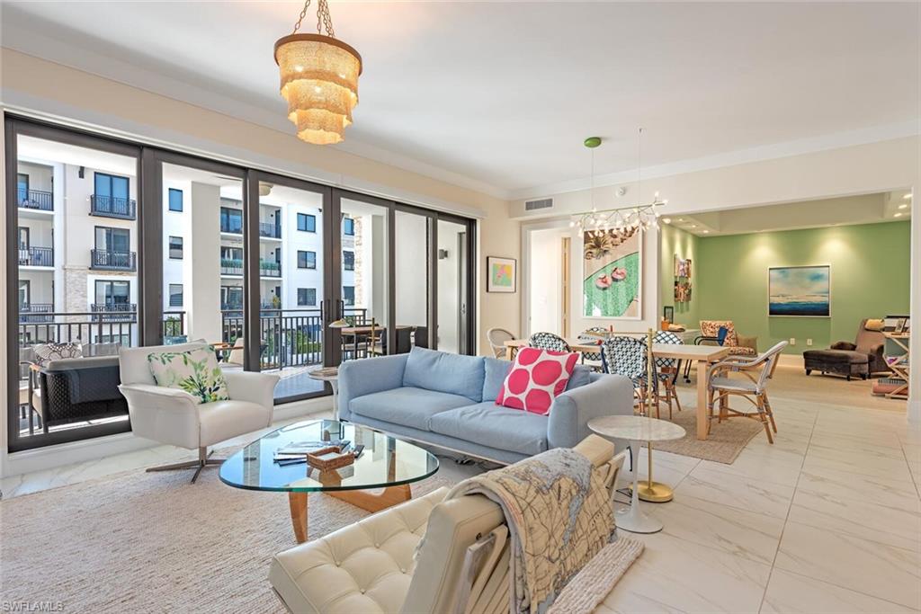 1135 3rd Avenue South, Unit 308 Naples, FL 34102 - Photo 3 of 18 a living room with furniture and a large window