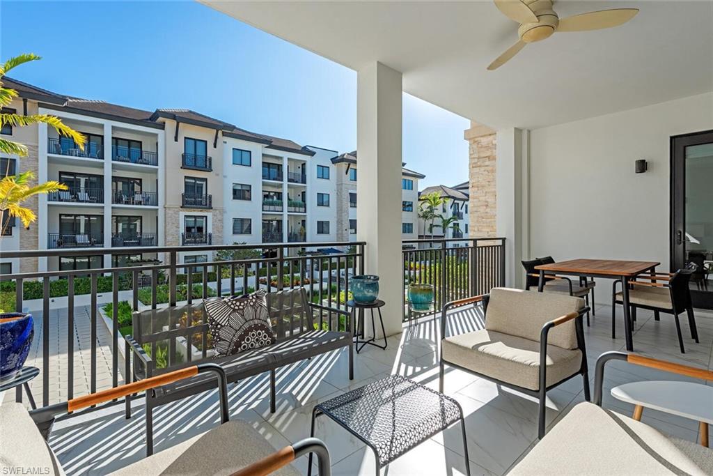 1135 3rd Avenue South, Unit 308 Naples, FL 34102 - Photo 4 of 18 a building outdoor space with patio furniture