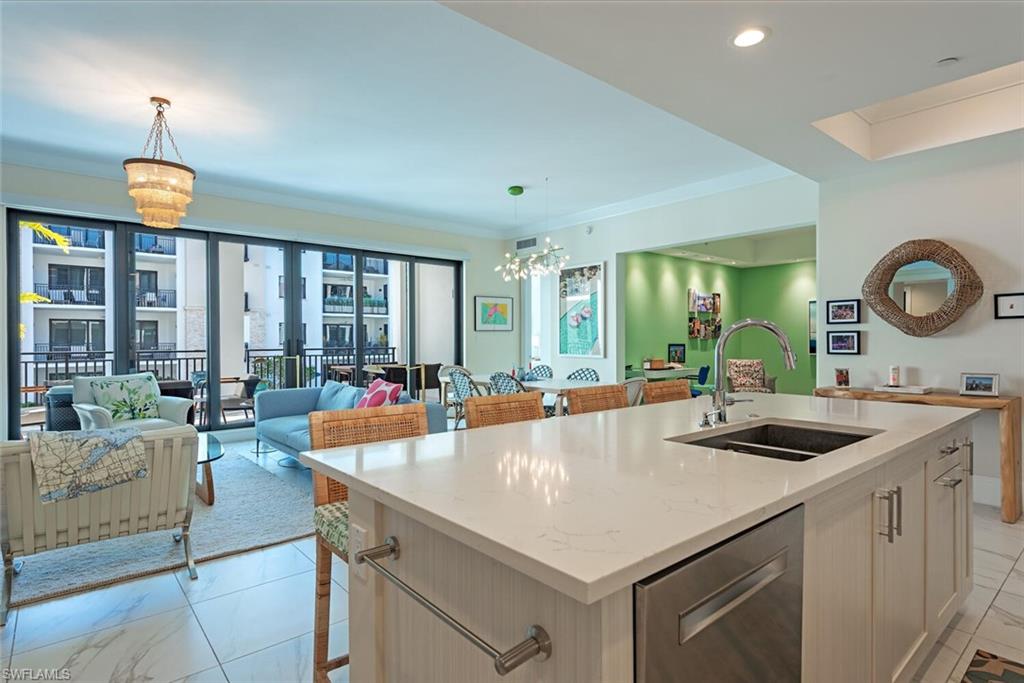 1135 3rd Avenue South, Unit 308 Naples, FL 34102 - Photo 8 of 18 a large white kitchen with a large window and couches