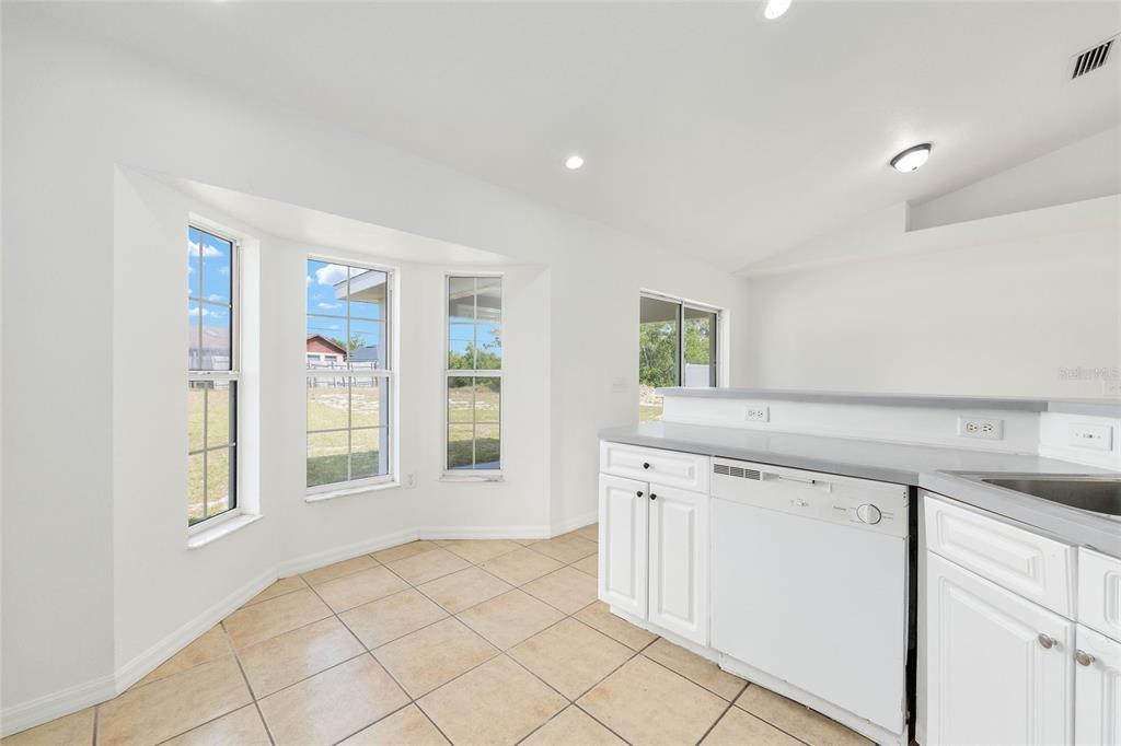 15434 Southwest 23rd Court Road Ocala, FL 34473 - Photo 21 of 41 a view of a kitchen with white cabinets and a window