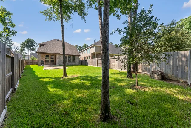 a view of a house with a yard and palm tree