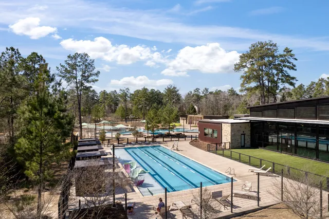 a view of house with swimming pool outdoor seating