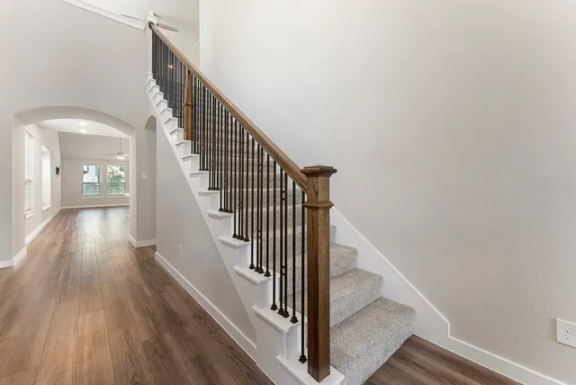 a view of entryway and hall with wooden floor