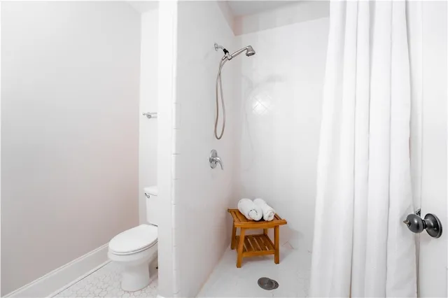 a bathroom with a toilet and a shower