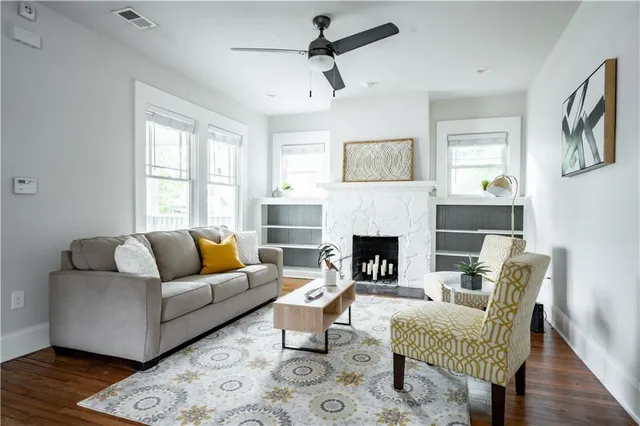 a living room with furniture and a fireplace