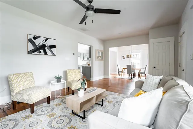 a living room with furniture and wooden floor
