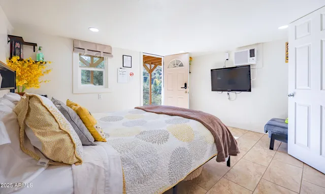 a bedroom with a bed and flat screen tv