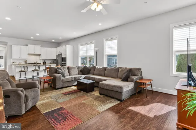 a kitchen with granite countertop white cabinets and chairs