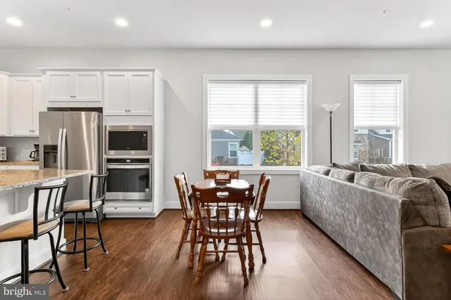 a kitchen with granite countertop white cabinets and a stove