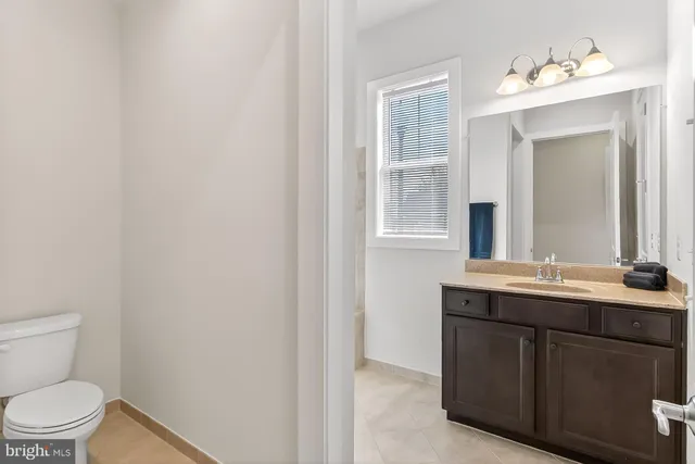 a front view of a house with a yard and potted plants