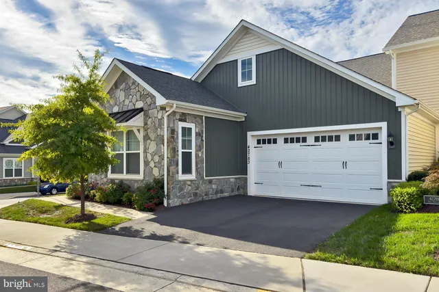 a kitchen with stainless steel appliances granite countertop a refrigerator stove microwave and sink