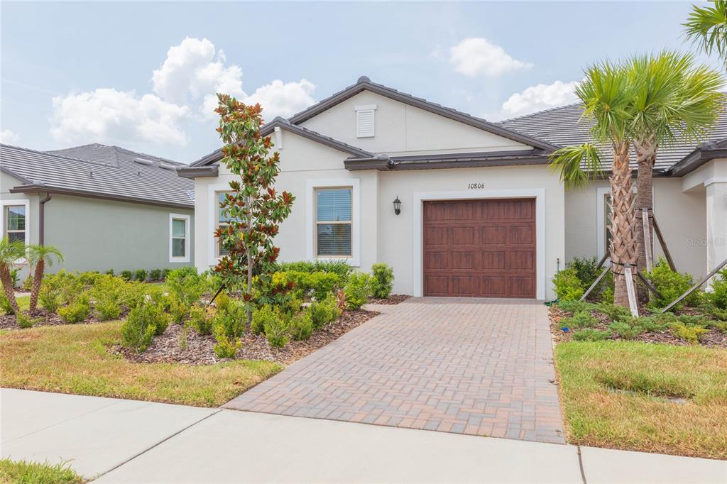 10806 Gable Dig Loop San Antonio, FL 33576 - Photo 3 of 73 a front view of a house with a yard and potted plants