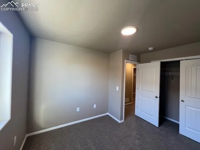 an empty room with closet area