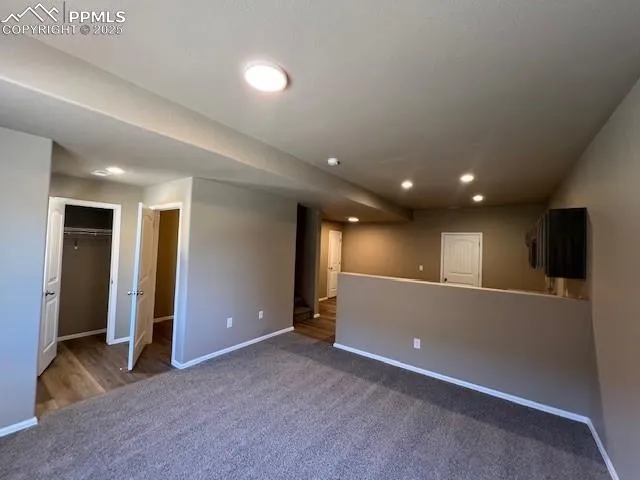 an empty room with closet and wooden floor