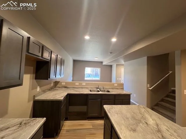 a kitchen with stainless steel appliances kitchen island granite countertop a sink stove and cabinets