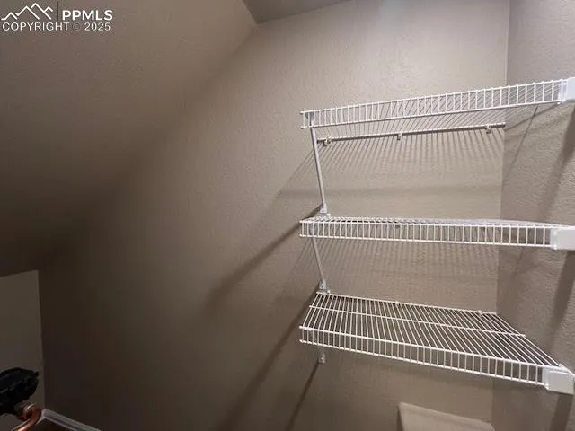 a view of a room with wooden floor and windows