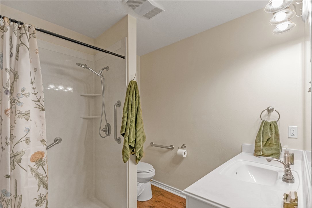 9997 Calhoun Road Bryan, TX 77808 - Photo 43 of 50 a bathroom with a sink a toilet and shower