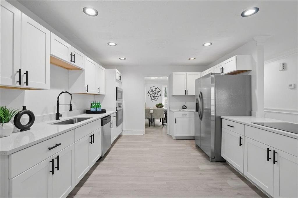 4645 Riveredge Cove Snellville, GA 30039 - Photo 11 of 43 a kitchen with white cabinets and refrigerator