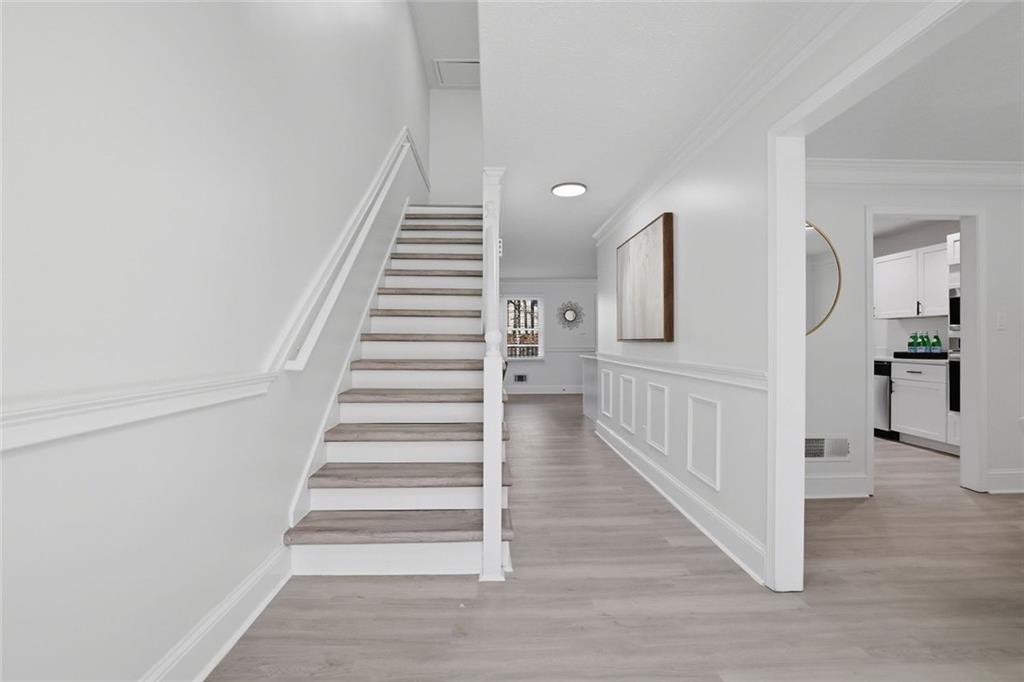 4645 Riveredge Cove Snellville, GA 30039 - Photo 17 of 43 a view of a hallway with wooden floor and entryway