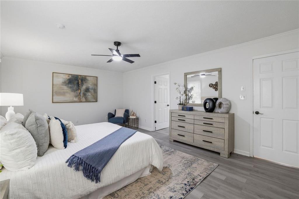 4645 Riveredge Cove Snellville, GA 30039 - Photo 20 of 43 a bedroom with a bed and a chandelier