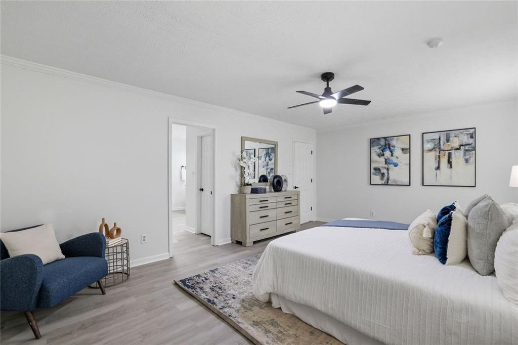 4645 Riveredge Cove Snellville, GA 30039 - Photo 21 of 43 a spacious bedroom with a bed and a couch