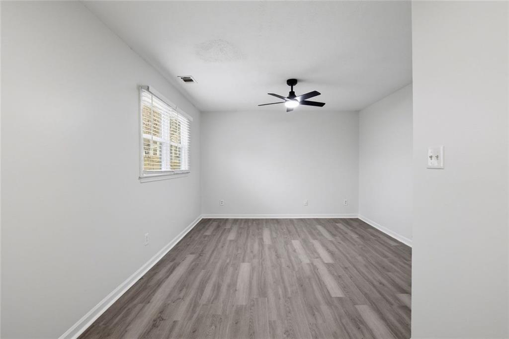 4645 Riveredge Cove Snellville, GA 30039 - Photo 23 of 43 wooden floor in an empty room with a window
