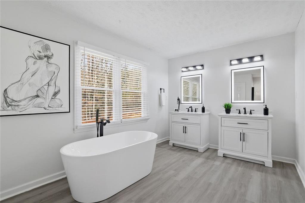 4645 Riveredge Cove Snellville, GA 30039 - Photo 30 of 43 a spacious bathroom with a bathtub and a sink